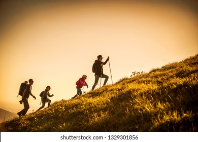 Family With Two Kids Have Hiking  Through The Mountains