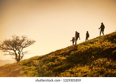 Family With Two Kids Have Hiking  Through The Mountains