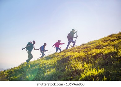 Family With Two Kids Have Hiking  Through The Mountains