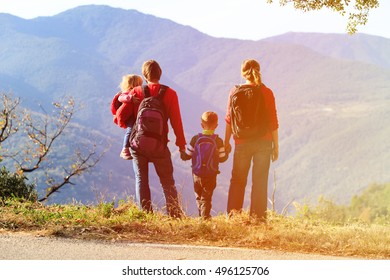 Family With Two Kids Hiking In Mountains