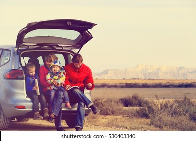 Family With Two Kids Travel By Car In Mountains