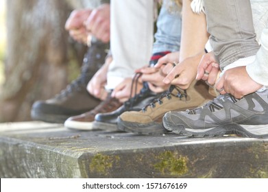 Family tying laces of hiking boots, close up - Powered by Shutterstock