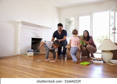 Family Unpacking Boxes In New Home On Moving Day - Powered by Shutterstock