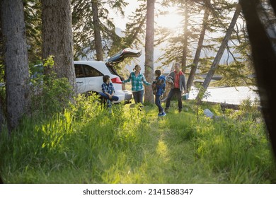 Family unpacking car at campsite - Powered by Shutterstock