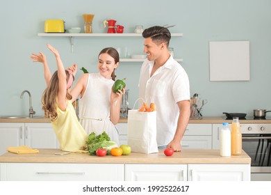 Family unpacking fresh products from market in kitchen - Powered by Shutterstock