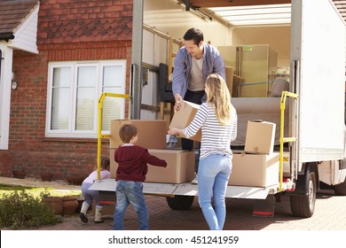 Family Unpacking Moving In Boxes From Removal Truck - Shutterstock ID 451241959