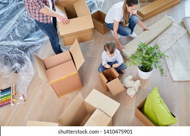 Family unpacks moving boxes when moving into the new home or house