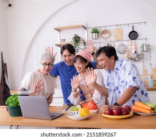 Family Using A Laptop Video Call In Kitchen To Talk To Children And Grandchildren Living Abroad.Technology Makes Communication Easy And Happy.Love,warmth,wishes For Parents And Children.Thai People.