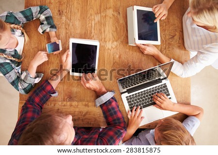 Family using new technology, overhead view
