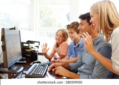 Family Using Skype In Home Office