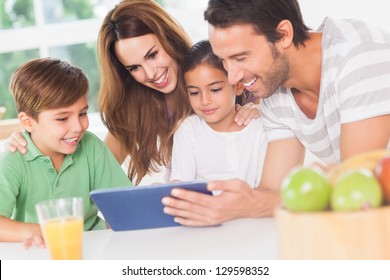 Family Using A Tablet Pc In Kitchen