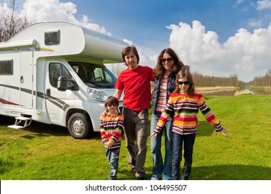 Family Vacation In Camping, Camper Trip. Happy Active Parents With Kids Travel On RV. Family Having Fun Near Their Motorhome. Spring Vacation Trip With Children.