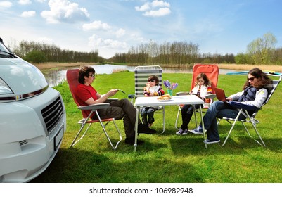 Family Vacation In Camping. Happy Active Parents With Kids Travel On Camper (RV). Family Having Fun  And Relaxing Near Their Motorhome. Spring Holiday Trip With Children.