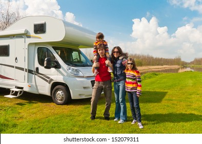 Family Vacation In Camping, Holiday Trip In Camper. Happy Active Parents With Kids Travel On RV. Family Having Fun Near Their Motorhome. Spring Vacation Trip With Children. 