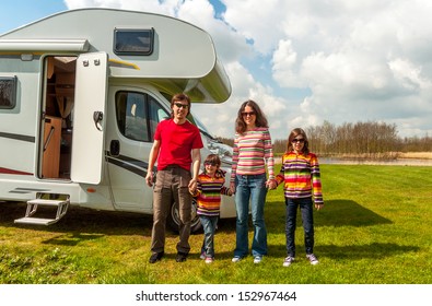 Family Vacation In Camping, Holiday Trip In Camper. Happy Active Parents With Kids Travel On RV. Family Having Fun Near Their Motorhome. Spring Vacation Trip With Children. 