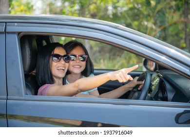 Family Vacation Holiday, Happy Family On A Road Trip In Their Car, Mom Driving Car While Her Daughter Sitting Beside, Mom And Daughter Are Traveling. Summer Ride By Automobile.