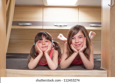 Family Vacation, RV Holiday Trip, Camping. Happy Smiling Kids Travel On Camper. Children In Motorhome Interior