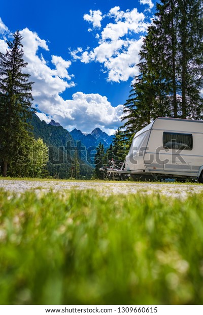Family vacation travel, holiday trip in motorhome\
RV, Caravan car Vacation. Beautiful Nature Italy natural landscape\
Alps.