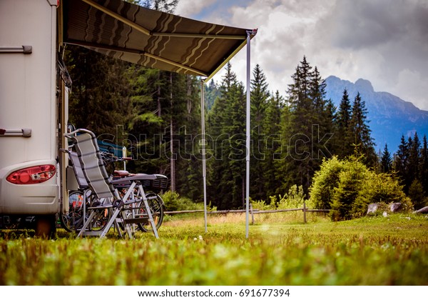 Family\
vacation travel, holiday trip in motorhome, Caravan car Vacation.\
Beautiful Nature Italy natural landscape\
Alps.