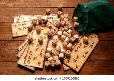 Family Vintage Interesting Lotto Bingo Game, Bingo Cards And Bingo Balls Lie On A Wooden Table