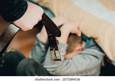 Family Violence And Aggression Concept - Furious Man Raised Punishment Fist With Belt Over Scared Child At Home.Toned.