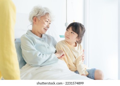 A family visiting an elderly inpatient. - Shutterstock ID 2231574899