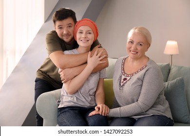 Family Visiting Young Woman With Cancer Indoors