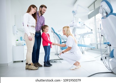 Family Visits Dentist In Dental Office For First Time Together