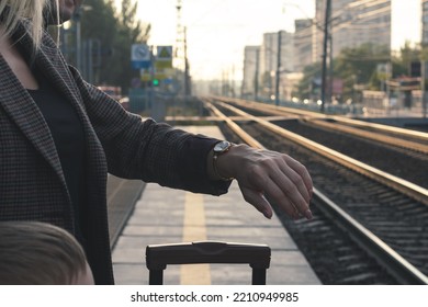 Family Waiting For The Arrival Of The Train On The Platform.woman Looking At Her Wristwatch. The Image Shows A Close-up Of A Woman's Hand With A Wristwatch