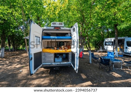 Similar – Image, Stock Photo Women resting and talking lying in tent over car