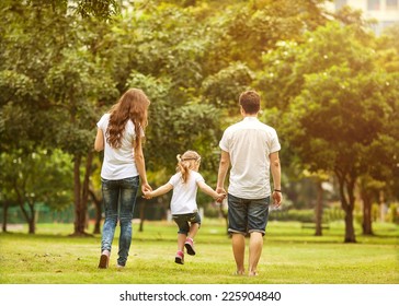 Family Walk In The Park, Happy At Sunset In Bangkok, Thailand.