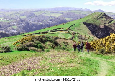 A Family Walking Along The South West Costal Path Towards Little Hangman, Devon, England On A Beautifully Sunny Day