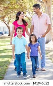 Family Walking Along Suburban Street