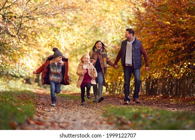 Family Walking Along Track In Autumn Countryside With Children Running Ahead - Powered by Shutterstock