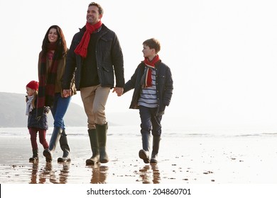 Family Walking Along Winter Beach