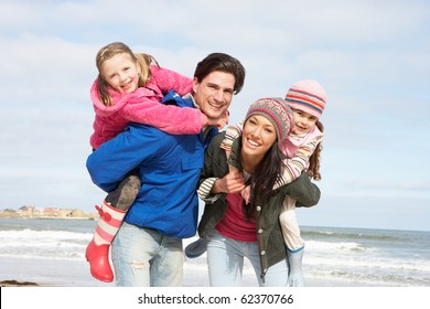 Family Walking Along Winter Beach