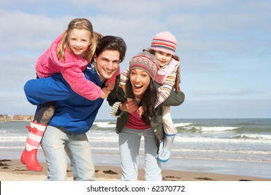 Family Walking Along Winter Beach