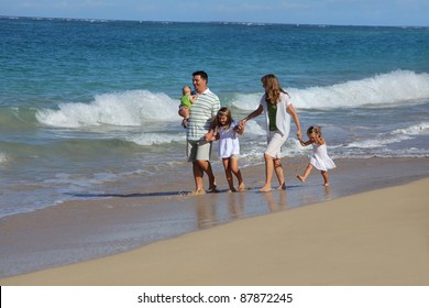 Family Walking At Beach Together