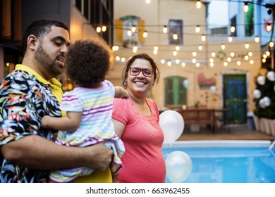 Family Walking Beside The Swimming Pool Party