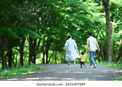 A family walking in a fresh green park - Powered by Shutterstock