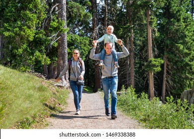 Family Walking Hiking Trail In Mountains In Summer