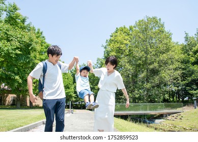 Family walking holding hands under the blue sky - Powered by Shutterstock