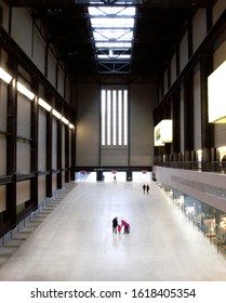 A Family Is Walking In Interior Of Tate Modern Turbine Hall In London, UK. 17.12.2013