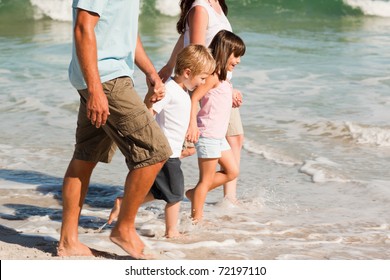 Family Walking On The Beach