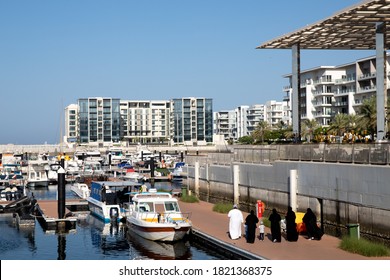 Family Walking On The Pier In The Marina With Boats. Al Mouj, The Wave, Muscat, Oman. September 7, 2020.