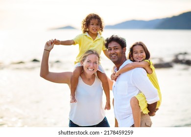 Family Walking On Tropical Beach. Parents And Kids Outdoor. Mother, Father And Children Play, Laugh, Run At Sea Side. Beautiful Young Interracial Couple On Summer Ocean Vacation. Travel With Kids.