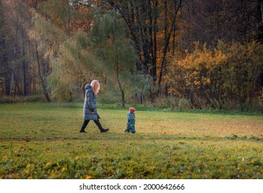 Family Walking In The Park In Autumn, Autumn Landscape, Baby Running Away From Mom, Parental Leave