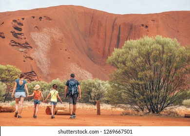 A Family Walking Through The Australian Bush Of The Outback Desert, The Red Centre Of Australia