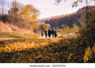 Family Walking Through autumn landscape