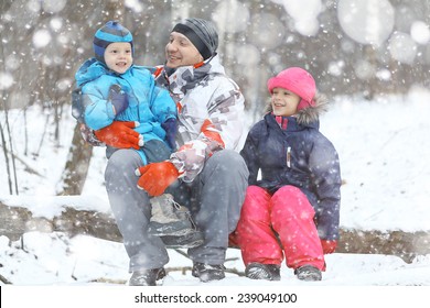 Family Walking In Winter Forest